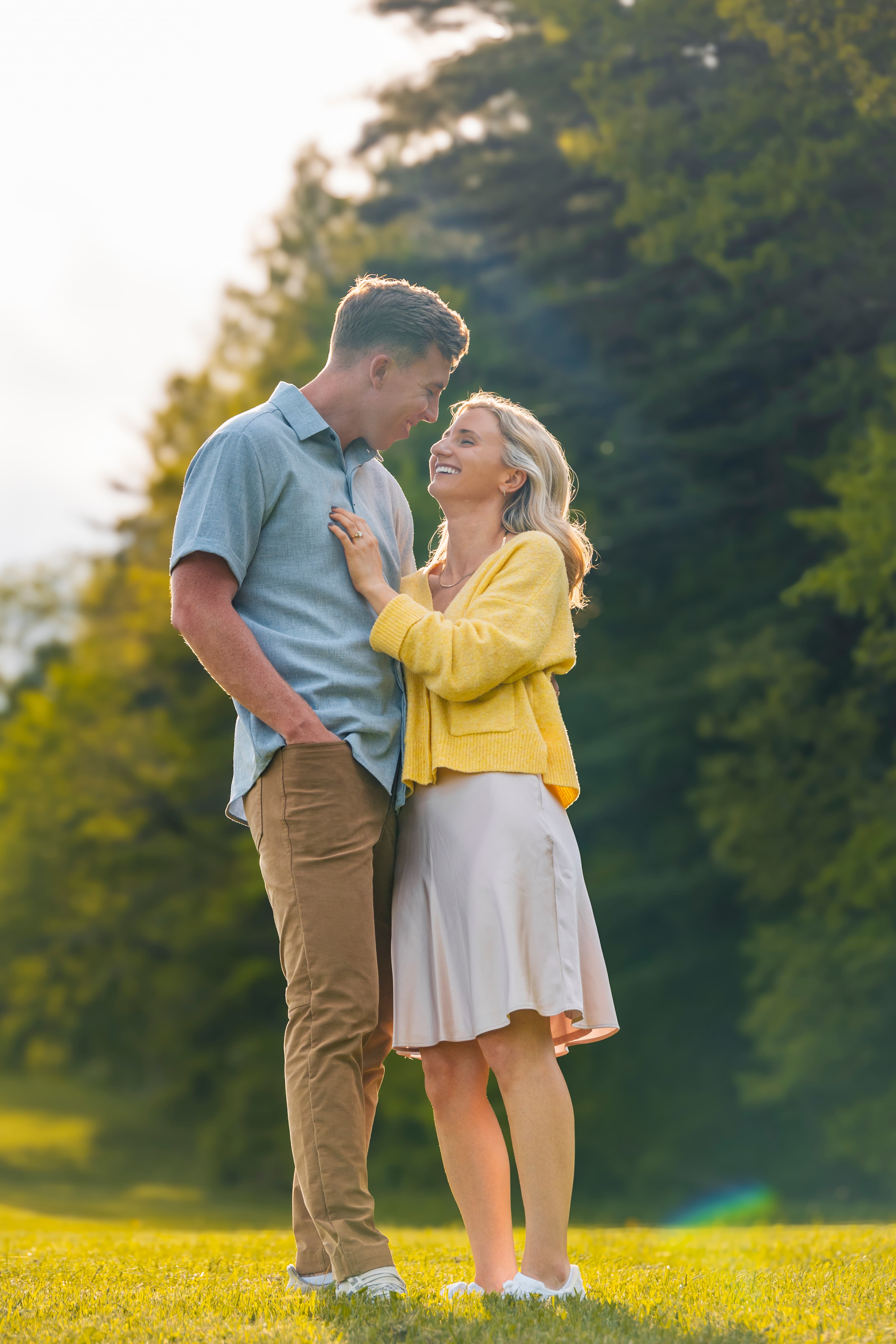 Couple laughing together in golden park light