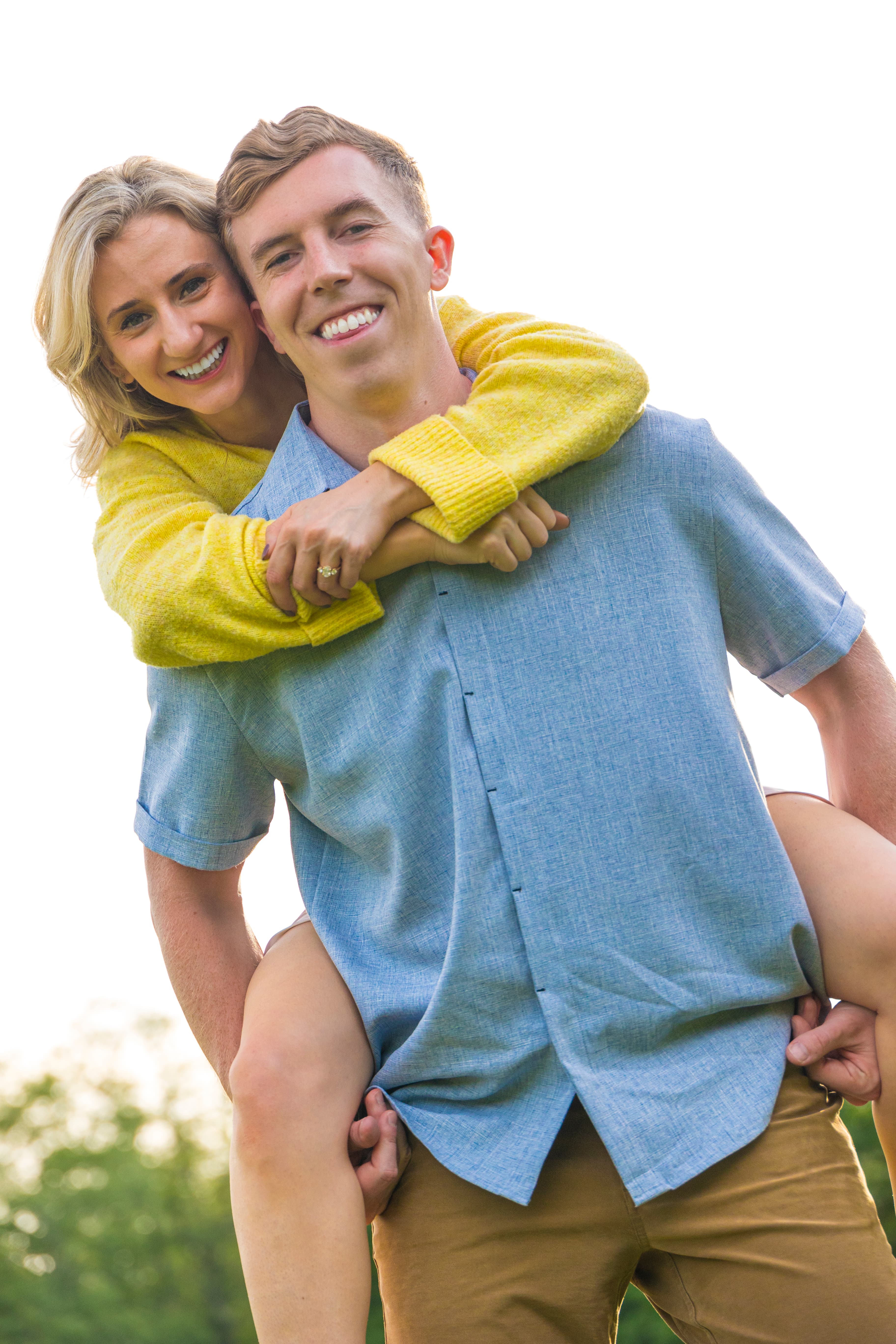 Couple laughing in a piggyback pose