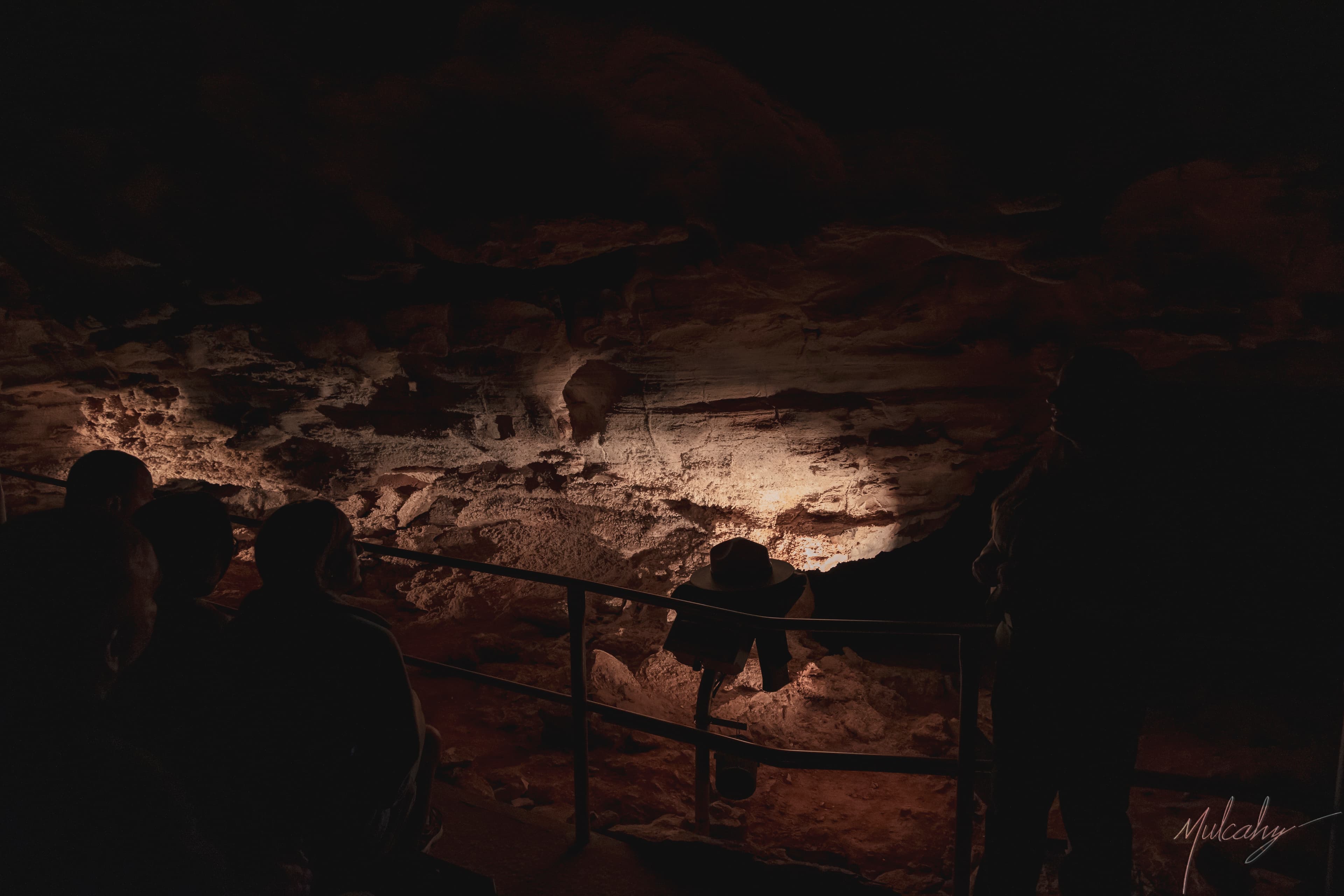Silhouetted visitors on a walkway inside Wind Cave, South Dakota